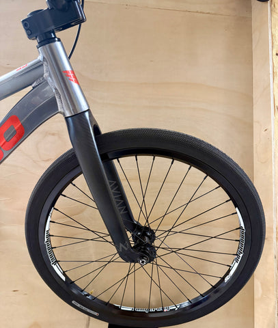 Close-up of a bicycle wheel with a wooden background